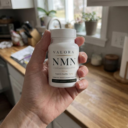A VALORA customer holding her NMN bottle