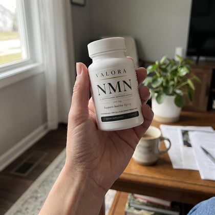 A VALORA customer holding her NMN bottle