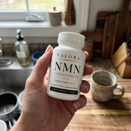 A VALORA customer holding her NMN bottle