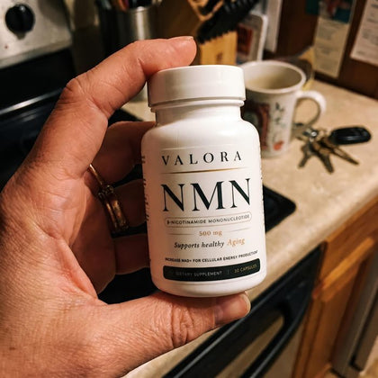 A VALORA customer holding her NMN bottle