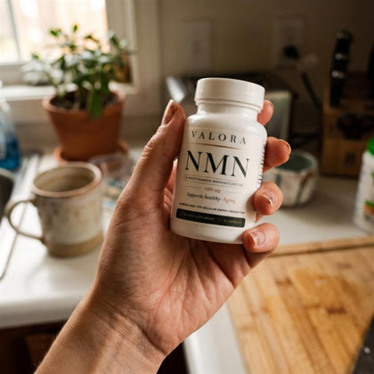 A VALORA customer holding her NMN bottle