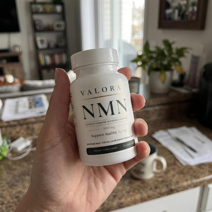 A VALORA customer holding her NMN bottle