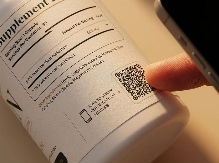 Close-up of a VALORA bottle label, a finger scanning the QR code that opens the batch Certificate of Analysis
