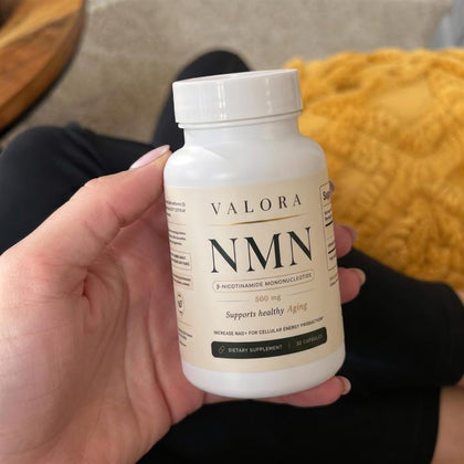 A VALORA customer holding her NMN bottle