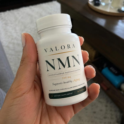 A VALORA customer holding her NMN bottle
