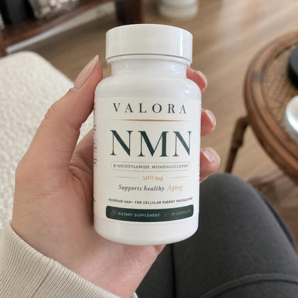 A VALORA customer holding her NMN bottle