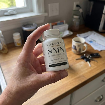 A VALORA customer holding her NMN bottle