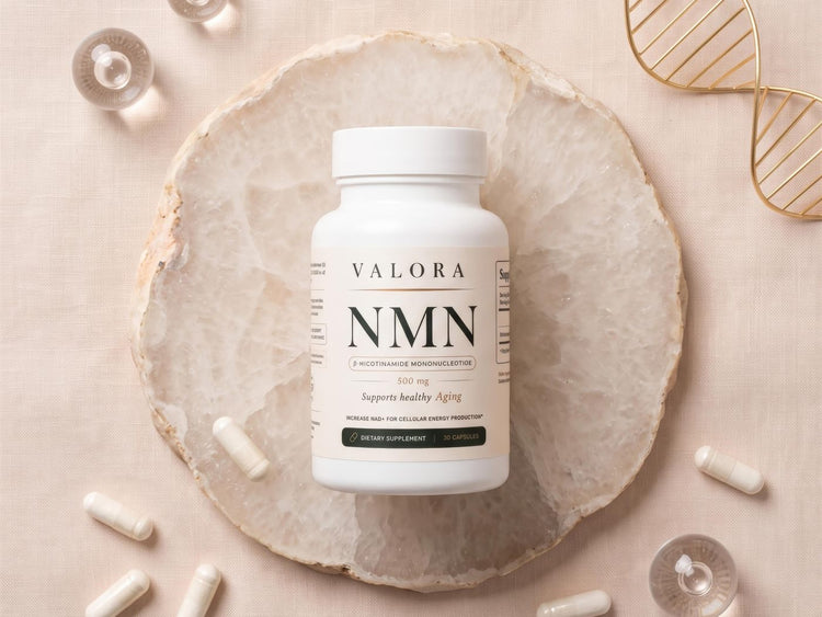 The VALORA NMN bottle resting on a crystal slice with loose capsules